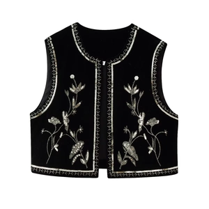 Detail of intricate floral embroidery and sequins on black velvet ethnic vest