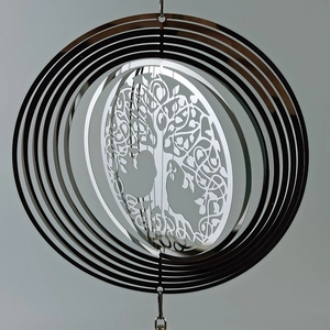 Macro detail of silver tree of life wind spinner with polished metallic finish
