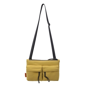 Minimalist yellow nylon crossbody bag with dual drawstring pockets and adjustable strap