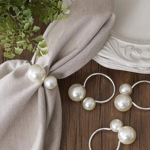 Detailed view of pearl napkin rings on a grey napkin for festive table decoration