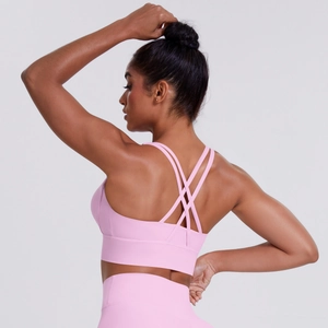 Pink sports bra with criss-cross back design showing elastic fabric and supportive straps