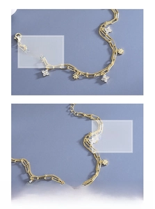 Detailed close-up of double-layer gold clover bracelet with sparkling zircon stones