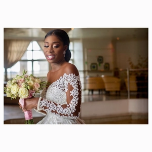 Elegant long sleeve lace wedding dress with off-shoulder design and vintage floral embroidery