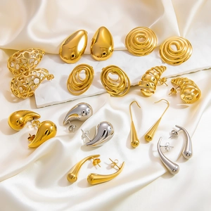 Vintage stainless steel teardrop and spiral stud earring set on white silk background