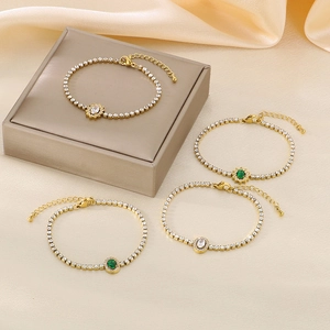 Vintage gold-plated titanium steel bracelet set with emerald green crystals on silk background