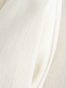Macro shot showing the detailed woven fabric texture of the off-white sleeveless vest