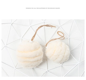 Close-up of white plush Christmas ornaments with textured faux fur and jute string