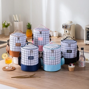 Insulated cylindrical lunch bags with shoulder straps in five colors for work and school