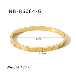 Detail view of 18k gold plated stainless steel bangle with heart patterns and zircon