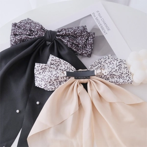Floral bow hair clips with pearls and long ribbons in black and beige colors