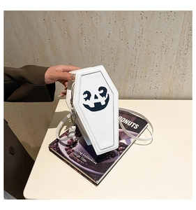 Close-up of white coffin-shaped crossbody bag with black pumpkin print for Halloween