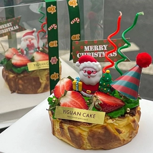 Christmas cake toppers set featuring a Santa Claus figurine and festive party hat decor