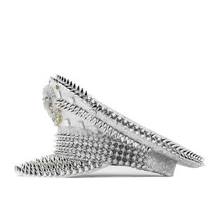 Close-up of silver sequin captain hat with metal studs and rhinestone lion badge detail