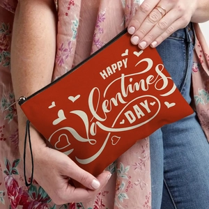 Orange canvas Happy Valentine's Day cosmetic bag with heart print and wristlet strap