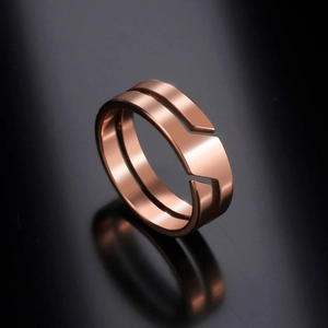 Polished rose gold double-layer geometric ring on a black reflective mirror surface
