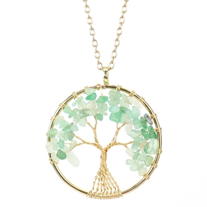 Detailed view of handmade golden wire Tree of Life pendant with green natural crystal stones
