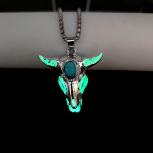 Luminous bull skull pendant with turquoise stone glowing in the dark detail view