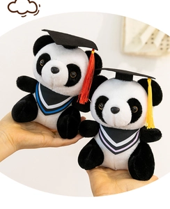 Detailed view of two graduation panda plush toys wearing black caps with colorful tassels