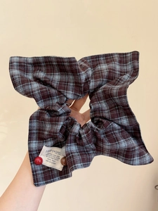Detail of checkered scrunchie in Maillard brown with beaded charms and textile texture