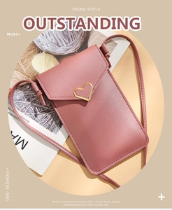 Detail of dusty pink crossbody phone bag with a gold heart-shaped metal buckle on the flap