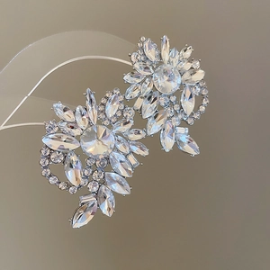 Detailed view of silver flower earrings with radiant marquise cut crystals and rhinestones