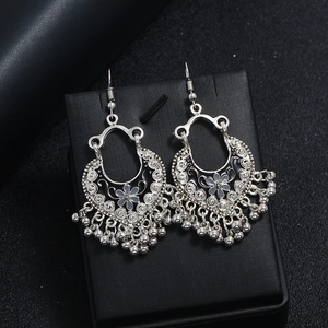 Silver vintage bohemian earrings with filigree flower pattern and bell tassels
