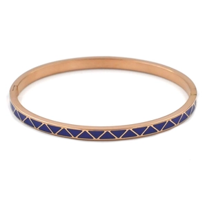 Detail of rose gold titanium steel bangle with blue geometric enamel and mechanical clasp