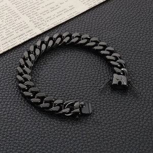 Detailed macro view of a black stainless steel Cuban link bracelet with a secure clasp buckle