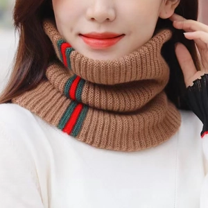 Detail of brown knit neck gaiter featuring classic red and green striped texture