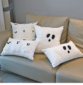 Set of 4 white boucle ghost embroidered cushion covers on a sofa for Halloween decor