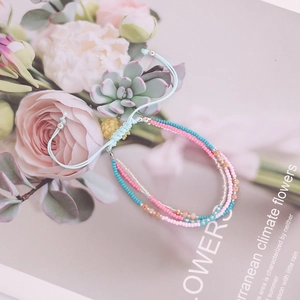 Multilayer bohemian seed bead bracelet in blue and pink with adjustable braided cord