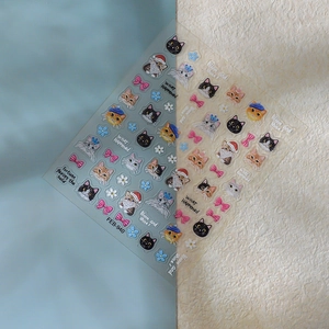 Detail of 5D embossed cat nail stickers with bows and flowers on dual backgrounds