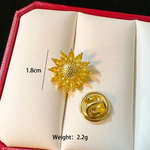 Macro shot of 1.8cm sunflower brooch with yellow marquise stones and metal honeycomb center