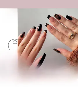 Detail of coffin-shaped press-on nails with leopard print and black matte finish