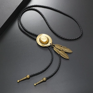 Detail of vintage bronze cowboy hat and feather bolo tie with black braided PU cord