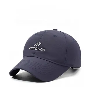 Detail of navy blue baseball cap featuring precision narason logo embroidery and peak stitching