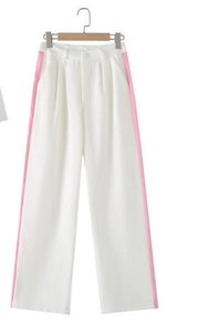 Detail of white wide-leg trousers featuring contrasting pink side stripe paneling