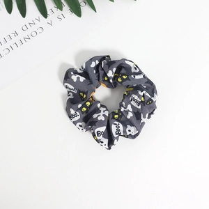 Gray Halloween scrunchie with white ghost and Boo! patterns on a white background