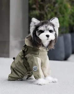 Detail of army green waterproof dog raincoat with integrated harness and outdoor patch