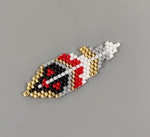 Detail view of woven seed beads in diamond patterns with black, red, and gold colors