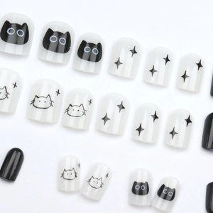 Short press-on nails with cute black cat and star patterns on white and black base
