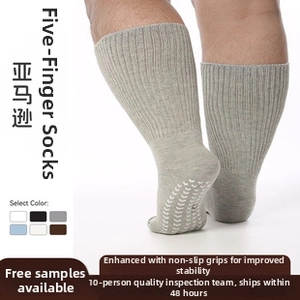 Detail of grey non-slip five-finger socks with white anti-skid dots for stability