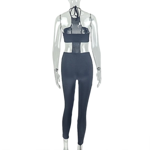 Detail of the backless cutout design and lace-up straps on this black slim jumpsuit