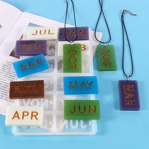 Detail view of rectangular monthly pendant silicone molds with colorful resin samples