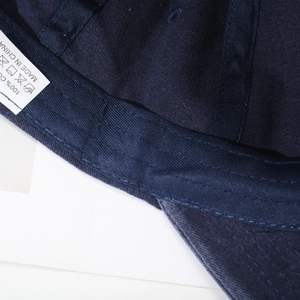 Navy blue vintage washed cotton baseball cap showing internal stitching and wash label details