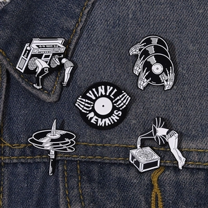 5-piece set of retro music enamel pins featuring vinyl records and skeletons on denim