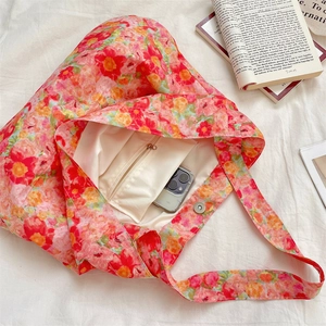 Floral tote bag interior showing pink flower print, beige lining, and zipper pocket