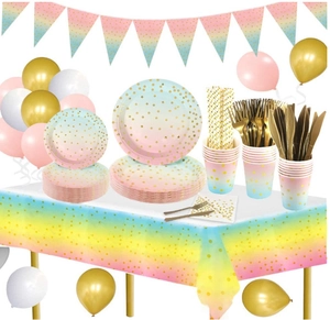 Close-up of pink and blue gradient party set with golden foil polka dots and balloons