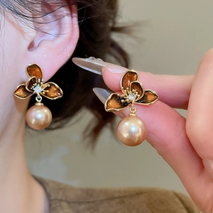 Detail of vintage 18K gold plated flower earrings with champagne pearl and zircon