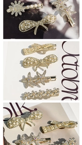 Detailed view of golden metal hair clips featuring pearls, rhinestones and bows
